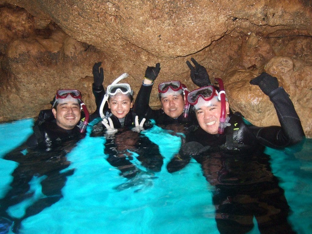 Group of 4 scuba divers at Maeda Point in Blue Cave