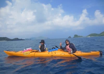 Two people canoe in ocean