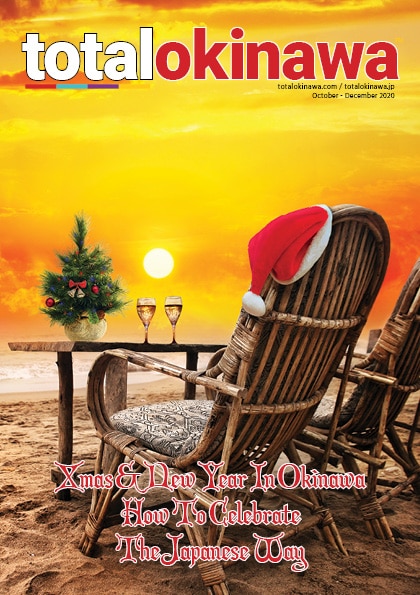 Deckchair on beach with santa hat and two glasses of champagne